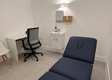 Relaxing treatment room at AtelieRx, St Albans, England, GB. Features a treatment bed and modern decor.
