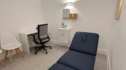 Relaxing treatment room at AtelieRx, St Albans, England, GB. Features a treatment bed and modern decor.