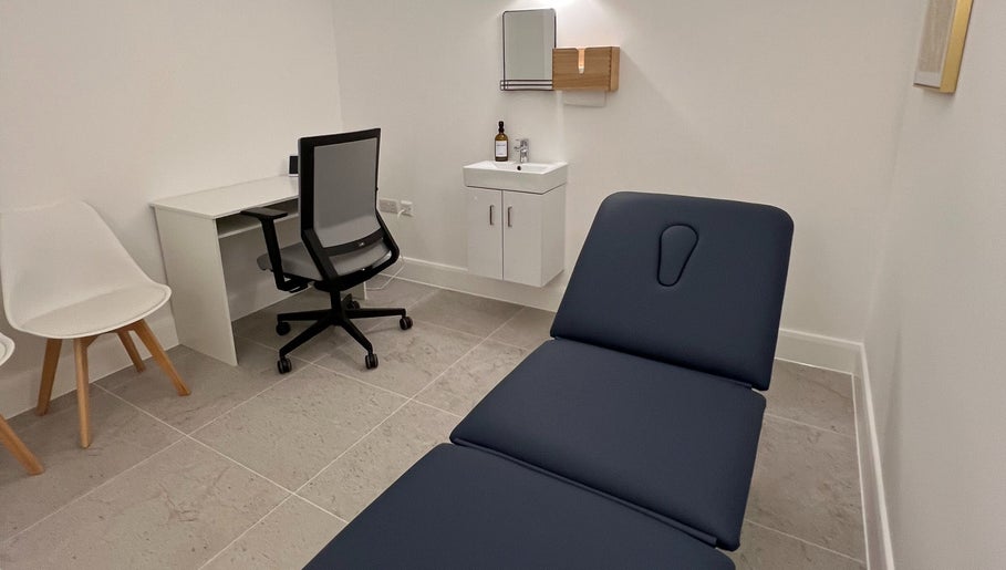 Modern treatment room at AtelieRx Medical Aesthetics, St Albans, England, GB with sleek design and comfortable seating.