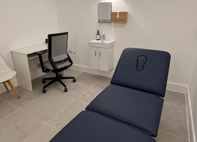 Modern treatment room at AtelieRx Medical Aesthetics, St Albans, England, GB with sleek design and comfortable seating.