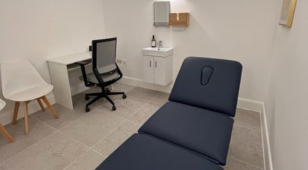 Modern treatment room at AtelieRx Medical Aesthetics, St Albans, England, GB with sleek design and comfortable seating.
