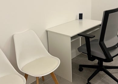 Modern seating area at AtelieRx Medical Aesthetics, St Albans, England, GB, with sleek chairs and desk.