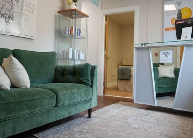 Welcoming lounge with green sofa at Tranquil Beauty By Teresa in Castlewellan, Northern Ireland, GB.