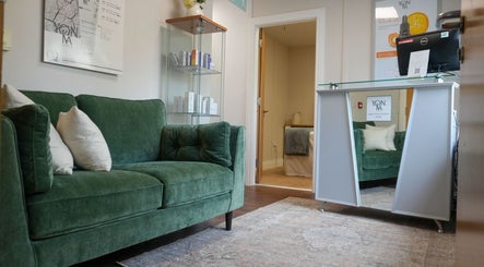 Welcoming lounge with green sofa at Tranquil Beauty By Teresa in Castlewellan, Northern Ireland, GB.