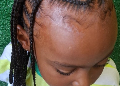 Detailed view of braided hairstyle at The Hair Fairy, Willemstad, Curaçao, CW showcasing intricate braiding.