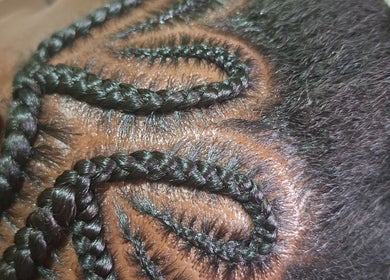 Intricate braided hairstyle at The Hair Fairy, Willemstad, Curaçao, CW showcasing detailed craftsmanship.
