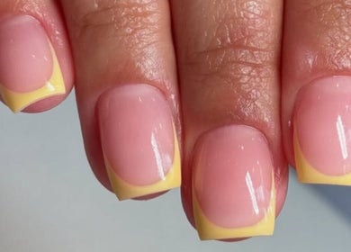Elegant yellow French tip manicure at MELGANAILS, دبي, دبي, AE, showcasing nail artistry.