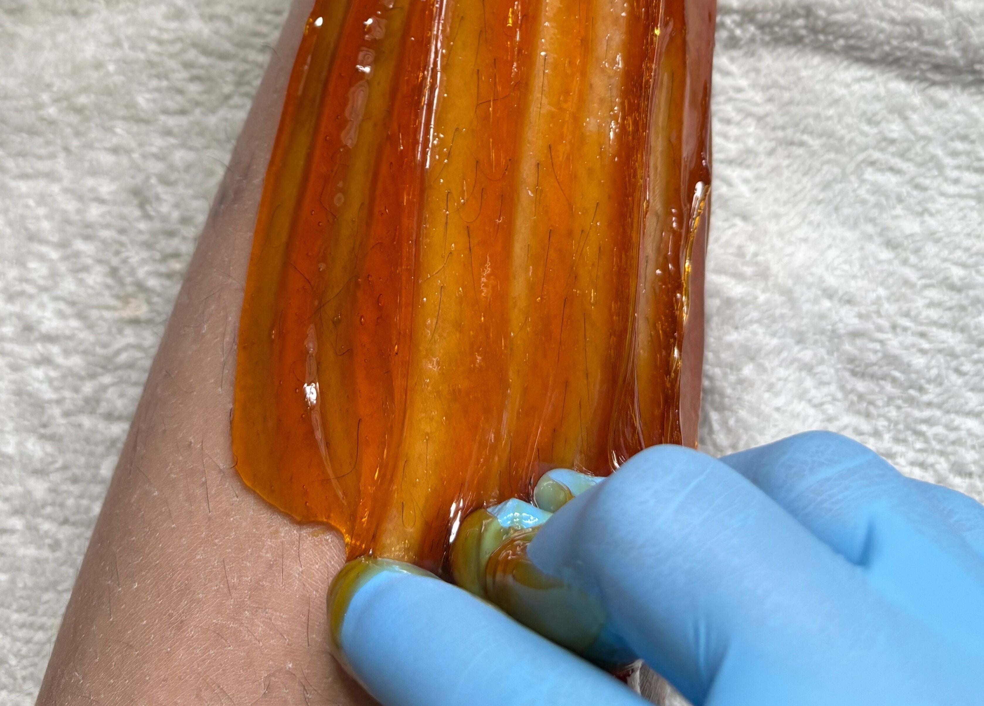 Honey waxing on arm at Bree's Honey Bar CW, Willemstad, Curaçao, CW. Relaxing wellness experience.