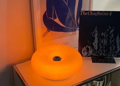 Cozy lamp illuminating a shelf at Girlh0od, Québec, Québec, CA, creating a calming ambiance.