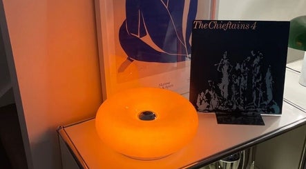 Cozy lamp illuminating a shelf at Girlh0od, Québec, Québec, CA, creating a calming ambiance.