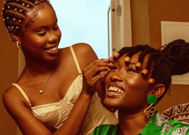 Two women enjoying a beauty session at Urban Roots co, CW, showcasing vibrant style and happiness.