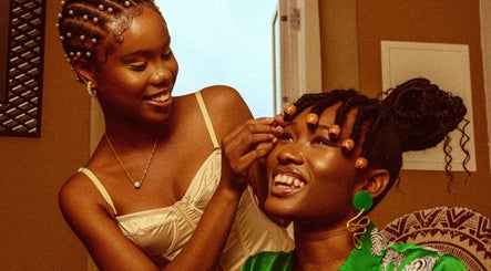 Two women enjoying a beauty session at Urban Roots co, CW, showcasing vibrant style and happiness.
