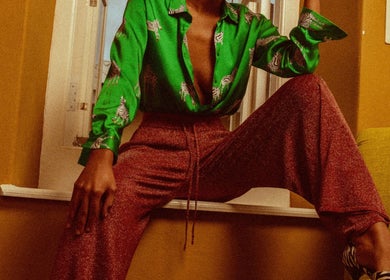 Stylish person in vibrant clothing at Urban Roots co, CW location, highlighting modern fashion elegance.