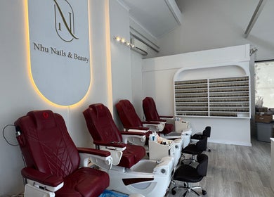 Nhu Nails and Beauty interior in Melbourne, Victoria, AU, featuring plush pedicure chairs and a nail polish display.