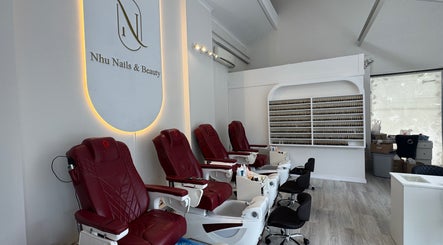 Nhu Nails and Beauty interior in Melbourne, Victoria, AU, featuring plush pedicure chairs and a nail polish display.