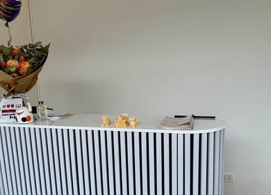 Welcoming reception at Nhu Nails and Beauty, Melbourne, Victoria, AU with fresh flowers and stylish decor.