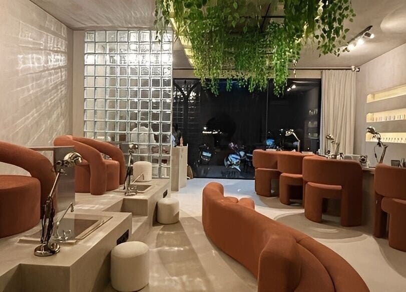 Modern interior of Mier Nails Salon in Bali, Bali, ID, with stylish seating and lush greenery overhead.
