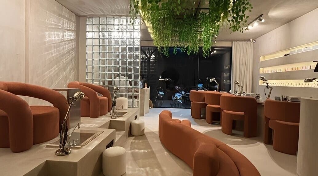 Modern interior of Mier Nails Salon in Bali, Bali, ID, with stylish seating and lush greenery overhead.