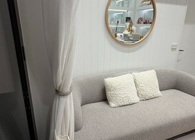 Elegant waiting area with cozy sofa and mirror at Keenest, Melbourne, Victoria, AU.