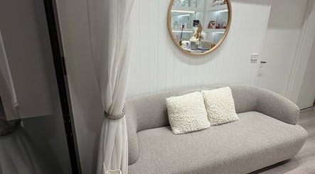 Elegant waiting area with cozy sofa and mirror at Keenest, Melbourne, Victoria, AU.