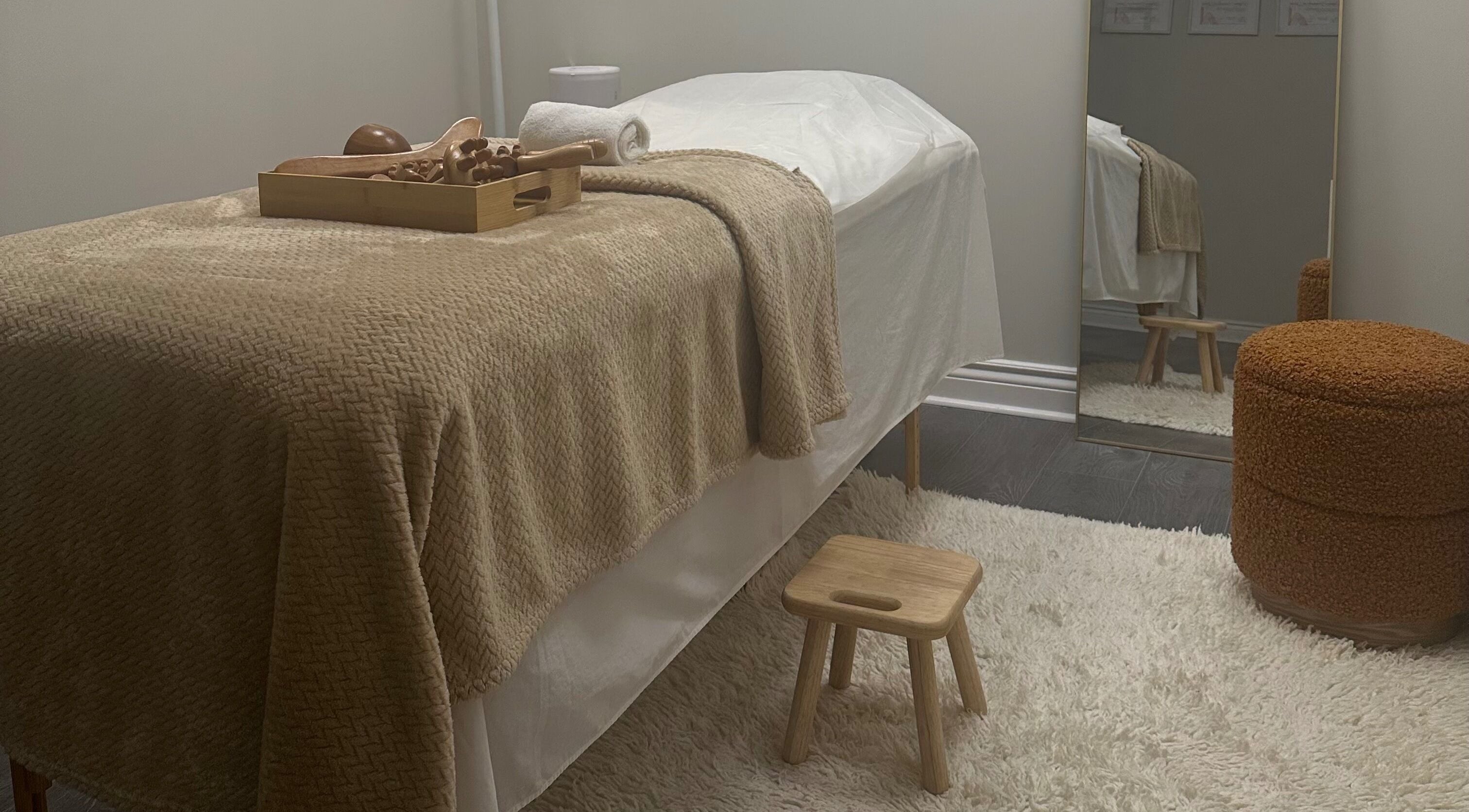 Cozy massage room at Pure Form, Toronto, Ontario, CA with a plush table and soothing decor.