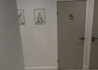 Calm hallway at Beauty by Abigail Jessica, Chesterfield, England, GB, featuring elegant brown doors and minimalist art.