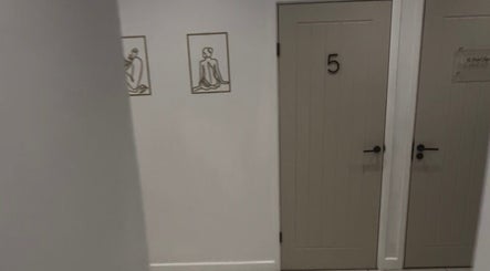 Calm hallway at Beauty by Abigail Jessica, Chesterfield, England, GB, featuring elegant brown doors and minimalist art.