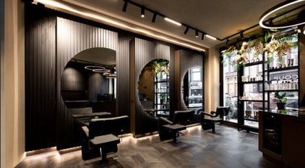 Modern interior of Hairsalon Coup D'état, Amsterdam, NL with sleek styling chairs and elegant decor.