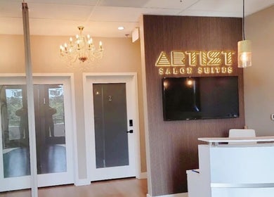 Elegant lobby of Drip Hq featuring chandeliers and a sleek desk in Garden Grove, California, US.