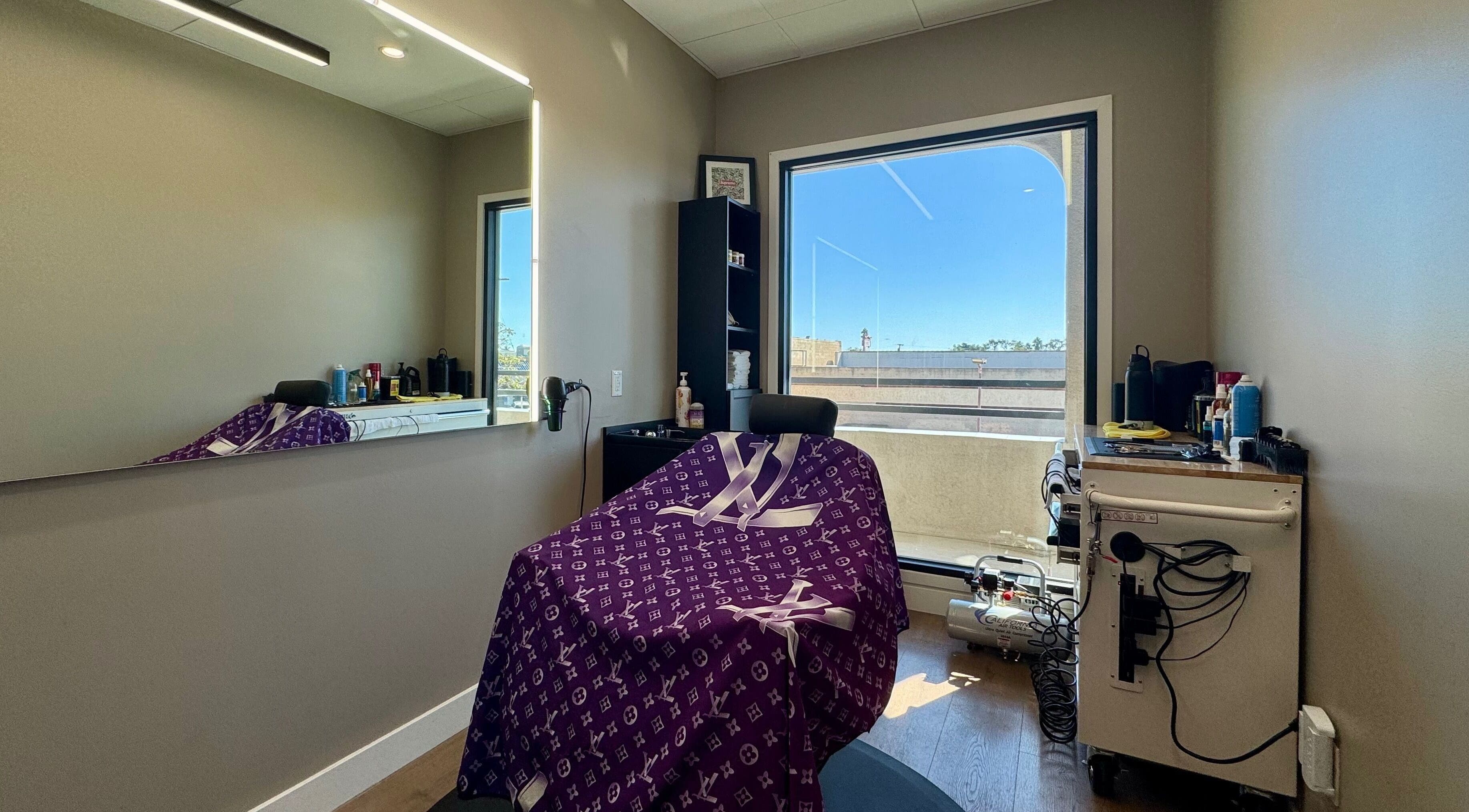 Barber chair in a modern salon at Drip Hq, Garden Grove, California, US with a large window view.