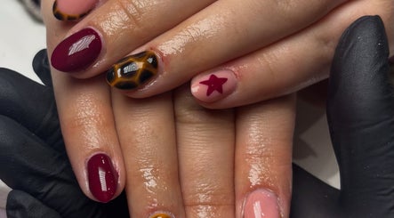 Stylish nail art featuring maroon, tortoiseshell, and star design at The Country Beauty Barn, Castlederg, Northern Ireland, GB.