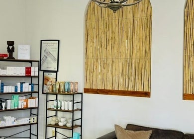 Relaxing seating area at Meraki Wellness Centre Olof Palme, Windhoek, Khomas Region, NA, featuring product shelves.
