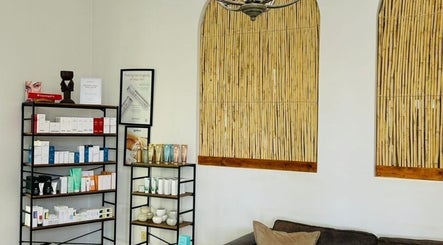 Relaxing seating area at Meraki Wellness Centre Olof Palme, Windhoek, Khomas Region, NA, featuring product shelves.