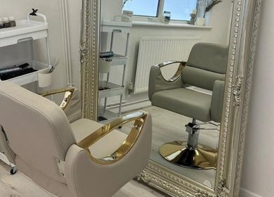 Chic salon chair and ornate mirror at Haus of Whites, Hilton, England, GB, embodying luxury and comfort.