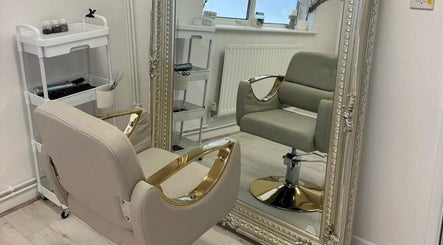 Chic salon chair and ornate mirror at Haus of Whites, Hilton, England, GB, embodying luxury and comfort.