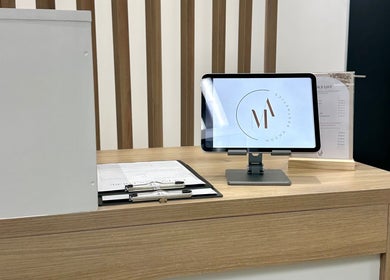 Reception desk at Mocha Aesthetics Clinic in Johannesburg, Gauteng, ZA with modern tablet display.