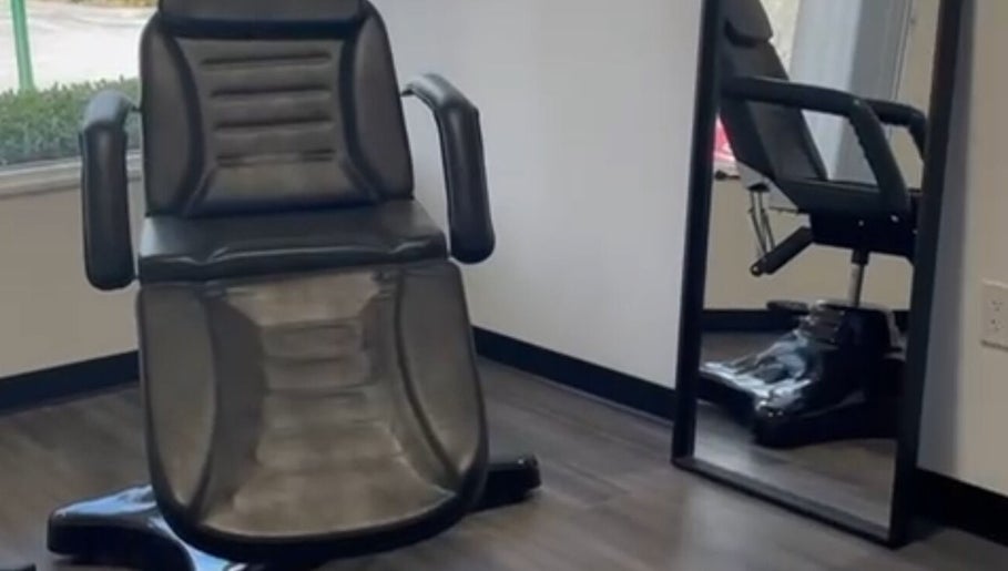 Comfortable salon chair at Skyl Aesthetic Miami, North Miami Beach, Florida, US, perfectly reflected in a mirror.