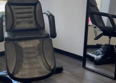 Comfortable salon chair at Skyl Aesthetic Miami, North Miami Beach, Florida, US, perfectly reflected in a mirror.