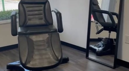 Comfortable salon chair at Skyl Aesthetic Miami, North Miami Beach, Florida, US, perfectly reflected in a mirror.