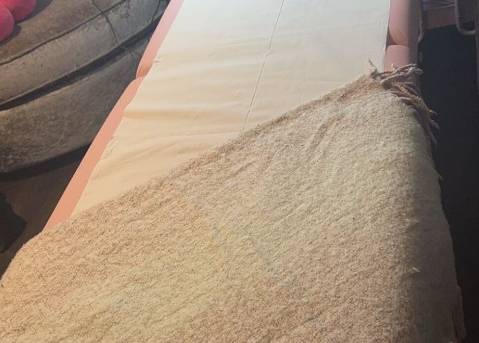 Relaxing massage table at Embellish Beauty, Hatfield, England, GB, set for a calming spa experience.