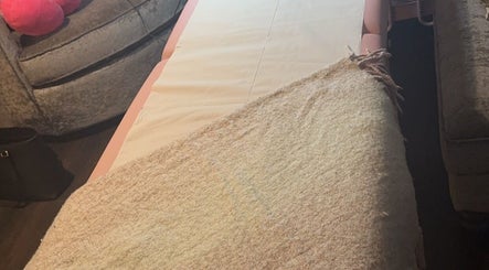 Relaxing massage table at Embellish Beauty, Hatfield, England, GB, set for a calming spa experience.