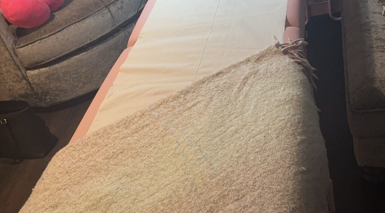 Relaxing massage table at Embellish Beauty, Hatfield, England, GB, set for a calming spa experience.