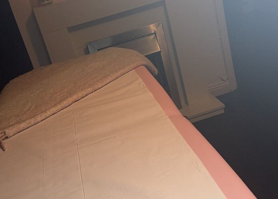 Cozy massage bed at Embellish Beauty, Hatfield, England, GB, with a soft towel and peaceful ambiance.