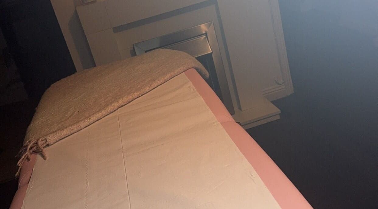 Cozy massage bed at Embellish Beauty, Hatfield, England, GB, with a soft towel and peaceful ambiance.