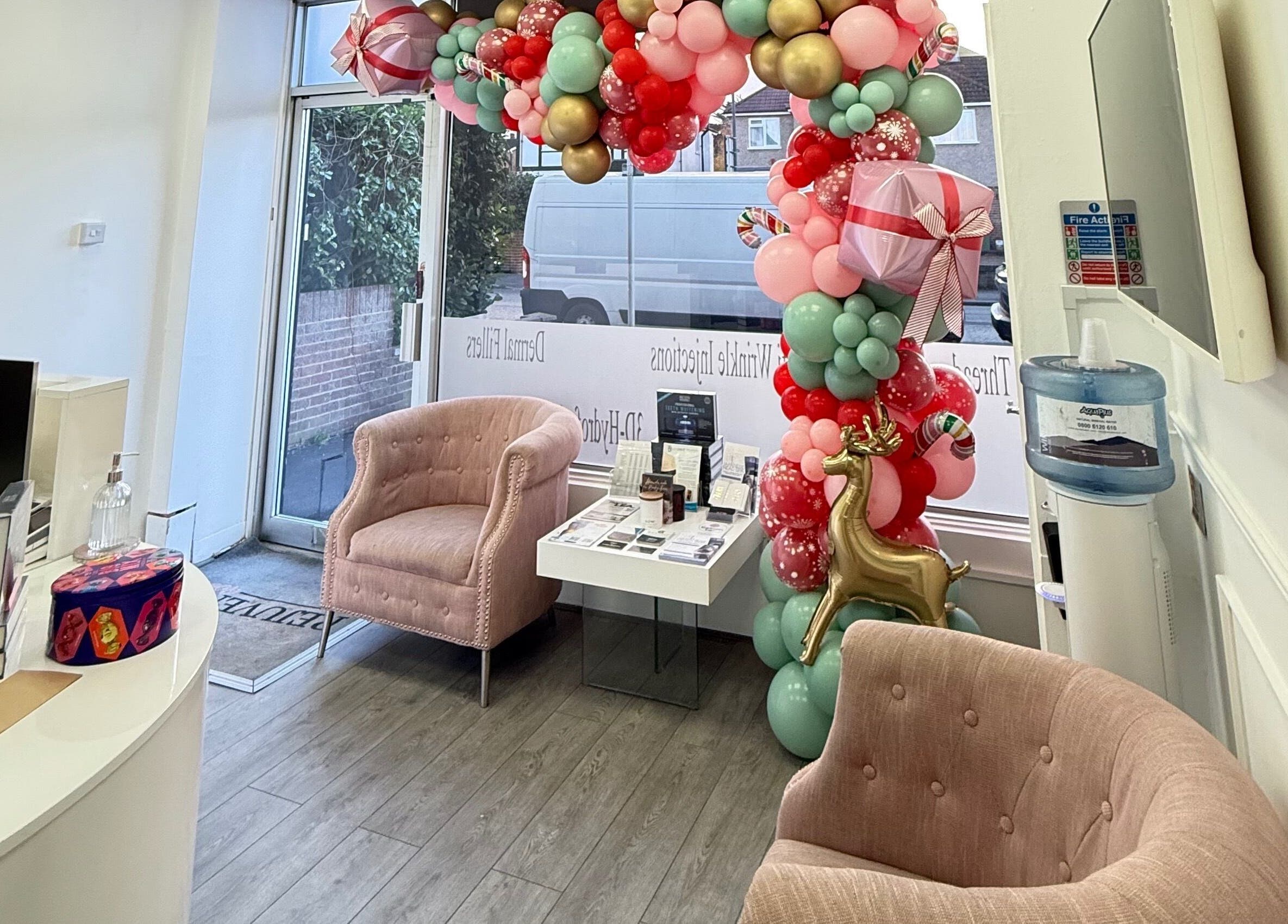 Welcoming decor at Katerina Aesthetics, Sidcup, England, GB featuring elegant balloon arch and cozy seating.