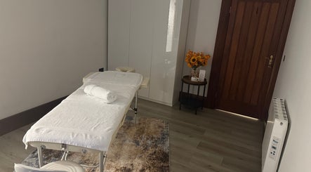 Tranquil massage room at Elysium Massage Abergavenny, Abergavenny, Wales, GB, featuring a cozy massage bed.