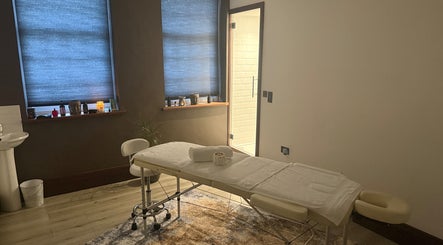Elysium Massage Abergavenny's tranquil therapy room in Abergavenny, Wales, GB, featuring a cozy massage table.