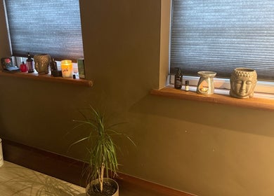 Peaceful decor in Elysium Massage Abergavenny, Abergavenny, Wales, GB featuring candles and Buddha statue.