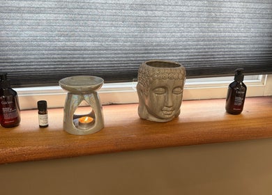 Aromatherapy setup with Buddha and oils at Elysium Massage Abergavenny, Abergavenny, Wales, GB.