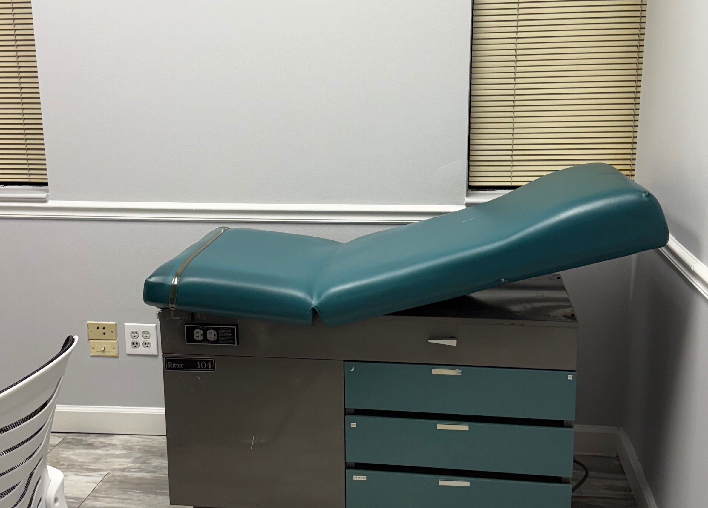 Modern treatment room at WETPARLOR, Lanham, Maryland, US, featuring an adjustable medical chair.